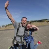 couple poses together in front of the camera before their skydive